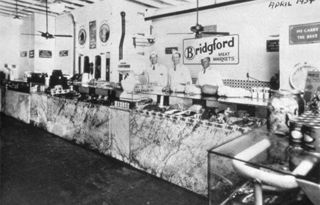 Black and white photo of workers inside historic Bridgford Meat Markets shop