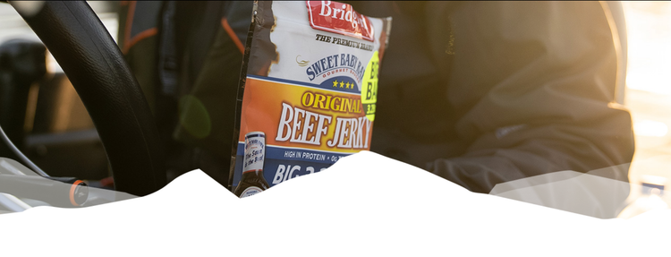 Person holding a package of Bridgford Sweet Baby Ray's Original Beef Jerky