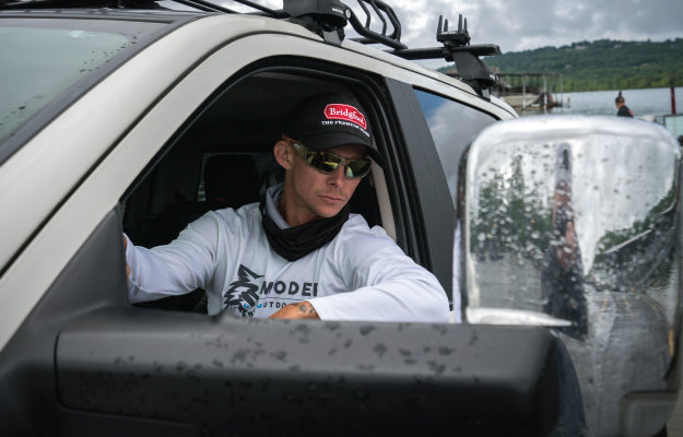 Man wearing a Bridgford hat sitting in the driver's seat of a truck