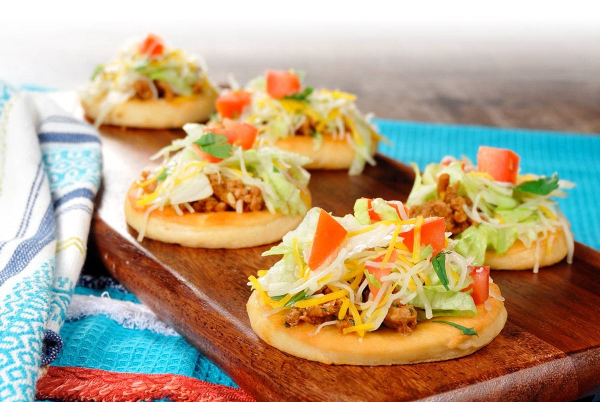 Bridgford mini flatbread tacos topped with meat, lettuce, and tomatoes