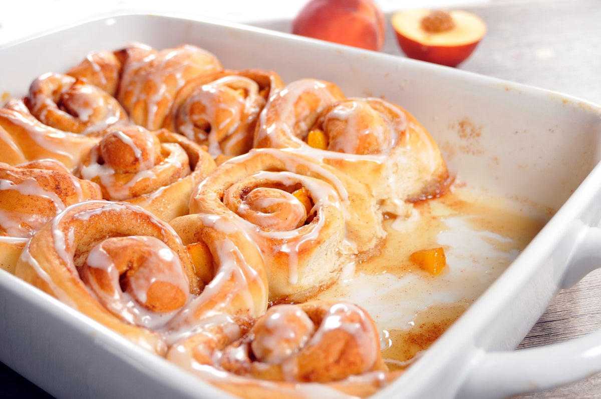Bridgford peach cinnamon rolls with icing in a baking dish
